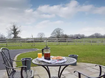 a table with a drink and a plate of food on it at Five Barred Gate Barn in Inglewhite