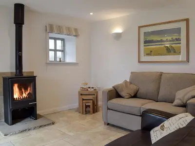 a living room with a couch and a fireplace at Five Barred Gate Barn in Inglewhite