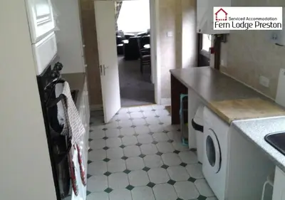 a kitchen with a washer and dryer on a floor at 4 Bedroom House at Fern Lodge Preston Serviced Accommodation - Free WiFi & Parking in Preston
