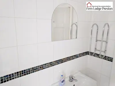 a bathroom with a sink and a mirror at 4 Bedroom House at Fern Lodge Preston Serviced Accommodation - Free WiFi & Parking in Preston