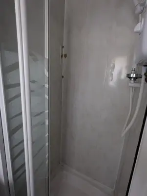 a shower with a glass door in a bathroom at OYO Wynnstay Hotel in Blackpool