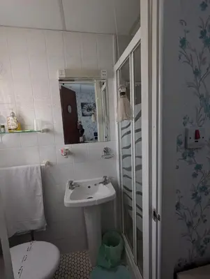 a small bathroom with a sink and a toilet at OYO Wynnstay Hotel in Blackpool