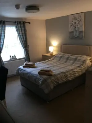 a bedroom with a bed with two towels on it at The Lord Nelson Inn B&B in Langho