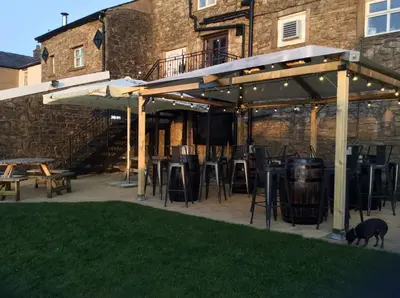 a group of tables and chairs under a pavilion at The Lord Nelson Inn B&B in Langho