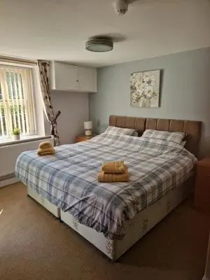 a bedroom with a bed with two towels on it at The Lord Nelson Inn B&B in Langho