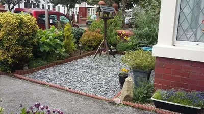 a garden with a bird feeder and some plants at EsJays at Knowles House in Lytham St Annes