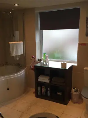 a bathroom with a tub and a sink and a toilet at EsJays at Knowles House in Lytham St Annes