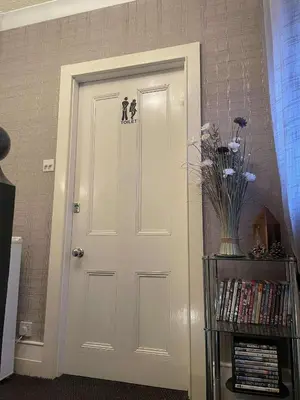 a white door with a sticker on it in a room at EsJays at Knowles House in Lytham St Annes