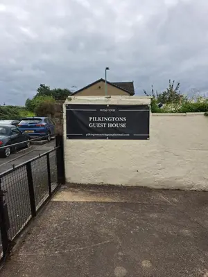 a sign on the side of a building at Pilkingtons Guest House Accrington in Accrington