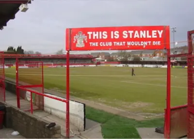 a sign at a soccer stadium with a field at Pilkingtons Guest House Accrington in Accrington