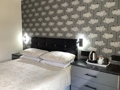 a bedroom with a bed with a black head board at Myrtle house in Blackpool
