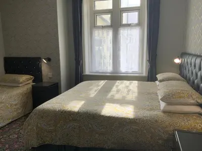 a bedroom with a bed and a window at Myrtle house in Blackpool