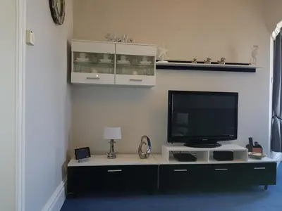 a living room with a television on a table at Promenade Apartments in Southport