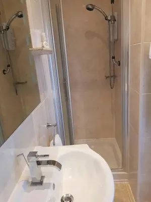 a bathroom with a sink and a shower at Promenade Apartments in Southport