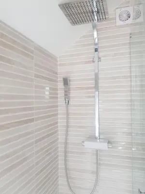 a shower with a shower head in a bathroom at Promenade Apartments in Southport
