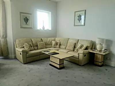 a living room with a couch and a table at Promenade Apartments in Southport
