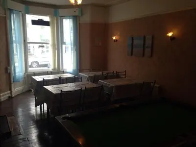 a room with tables and chairs and a pool table at The Driftwood Hotel in Blackpool