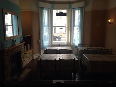 a room with several beds in a room with a window at The Driftwood Hotel in Blackpool