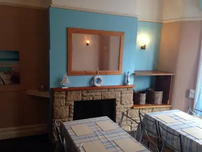 a living room with a fireplace and a mirror at The Driftwood Hotel in Blackpool