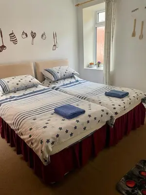 a large bed in a bedroom with two pillows on it at The Blue Moon in Blackpool