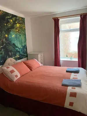a bedroom with a bed with two towels on it at The Blue Moon in Blackpool