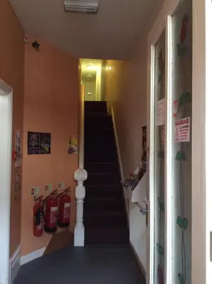 a hallway with a staircase with fire hydrants at The Blue Moon in Blackpool