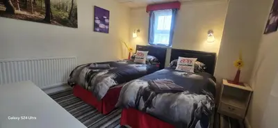 a room with two beds in a room at BUKHARI Hotel in Blackpool