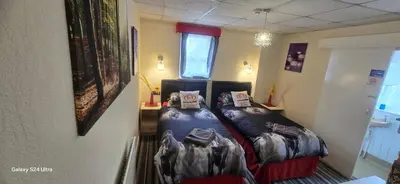 a bedroom with a bed with pillows on it at BUKHARI Hotel in Blackpool