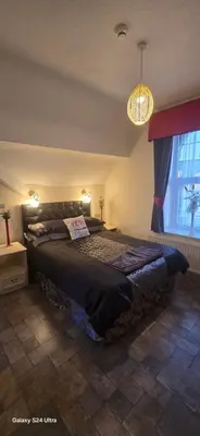 a bedroom with a large bed in a room at BUKHARI Hotel in Blackpool