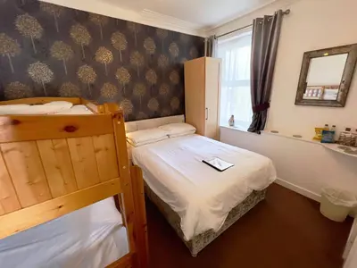 a small bedroom with a bunk bed and a mirror at Bella Vista Lodge in Blackpool