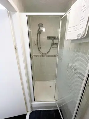 a shower with a glass door in a bathroom at Bella Vista Lodge in Blackpool