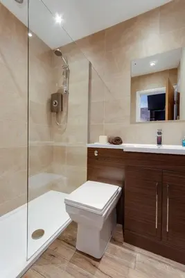 a bathroom with a toilet and a shower and a sink at Tom Thumb Apartments in Liverpool