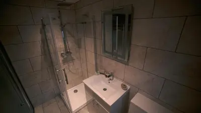 a bathroom with a sink and a shower with a mirror at No.10 Preston in Preston
