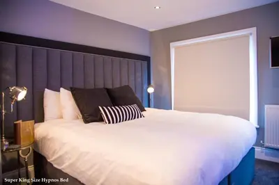 a bedroom with a large bed and a large window at No.10 Preston in Preston