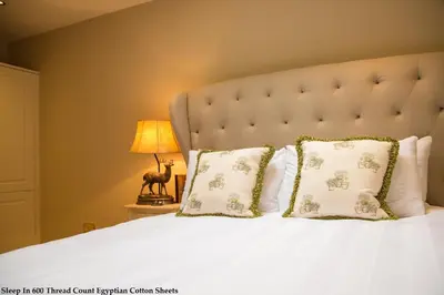 a bedroom with a white bed with pillows and a lamp at No.10 Preston in Preston