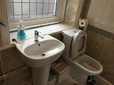 a bathroom with a sink and a toilet and a window at Aparthotel Coniston in Blackpool
