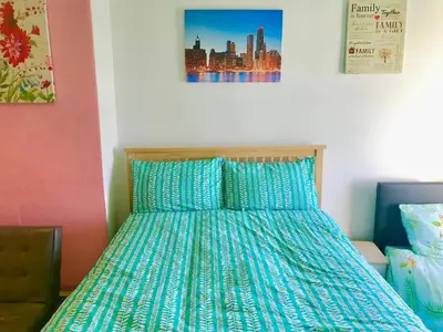 a bedroom with a bed with a blue comforter at Aparthotel Coniston in Blackpool