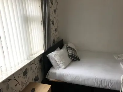 a room with a bed with a pillow and a window at The Orbiston in Blackpool