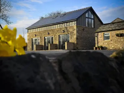 a large brick house with a black roof at 3 Millstones Inn in West Bradford