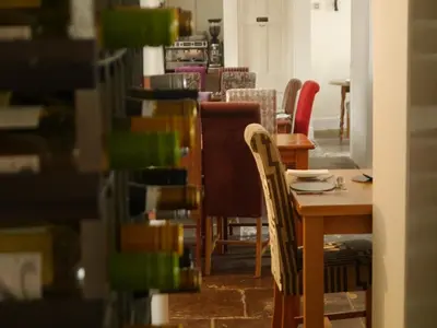 a dining room with a table and chairs at 3 Millstones Inn in West Bradford