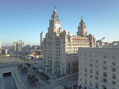 a large building with a clock tower on top of it at Excelsior Apartments - Liverpool Central - Free Parking - AirCon in Liverpool