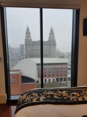 a bedroom window with a view of a large building at Excelsior Apartments - Liverpool Central - Free Parking - AirCon in Liverpool