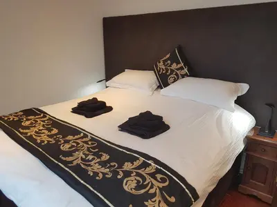 a bed with two towels on top of it at Excelsior Apartments - Liverpool Central - Free Parking - AirCon in Liverpool