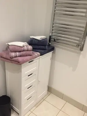 a pile of towels sitting on a counter in a room at Excelsior Apartments - Liverpool Central - Free Parking - AirCon in Liverpool