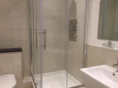 a bathroom with a shower and a toilet and a sink at Excelsior Apartments - Liverpool Central - Free Parking - AirCon in Liverpool