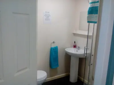 a bathroom with a toilet and a sink at The Kirkview in Blackpool