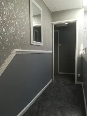 an empty room with a door and a mirror at The Kirkview in Blackpool