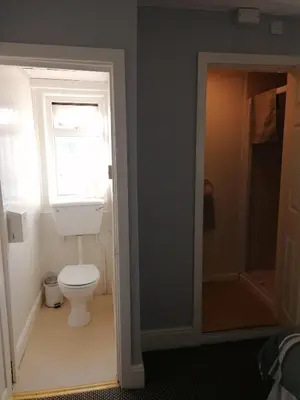 a bathroom with a toilet and a window at The Kirkview in Blackpool
