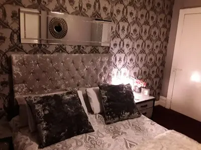 a bedroom with a bed and a lamp on a table at Mayfair Hotel in Blackpool