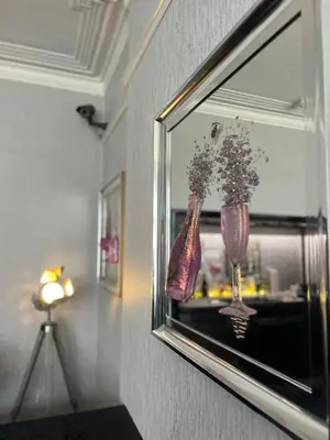 a picture of a vase with flowers in a window at Mayfair Hotel in Blackpool